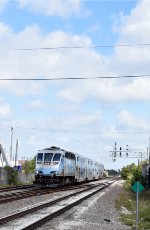 A southbound Magonia Park-Miami Airport Tri-Rail train arriving into Metrorail Transfer Station in Hialeah behind a BL36PH